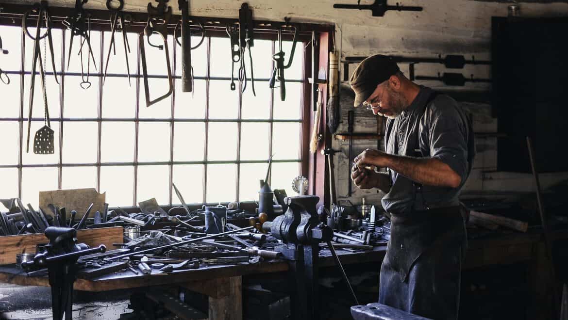 Handwerker arbeitet in der Werkstatt mit Werkzeugen und Maschinen.